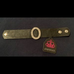 Never worn, black strap snap bracelet with simulated rhinestone oval center